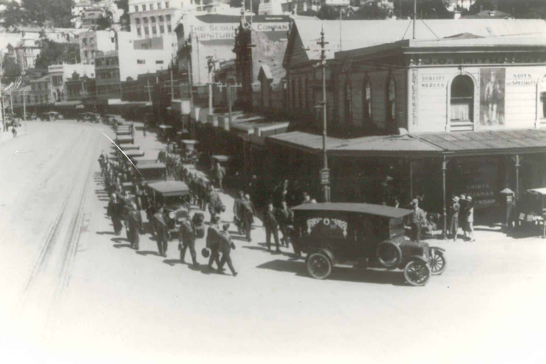 Mourners and a hearse at the funeral of Sir Frederic Truby King