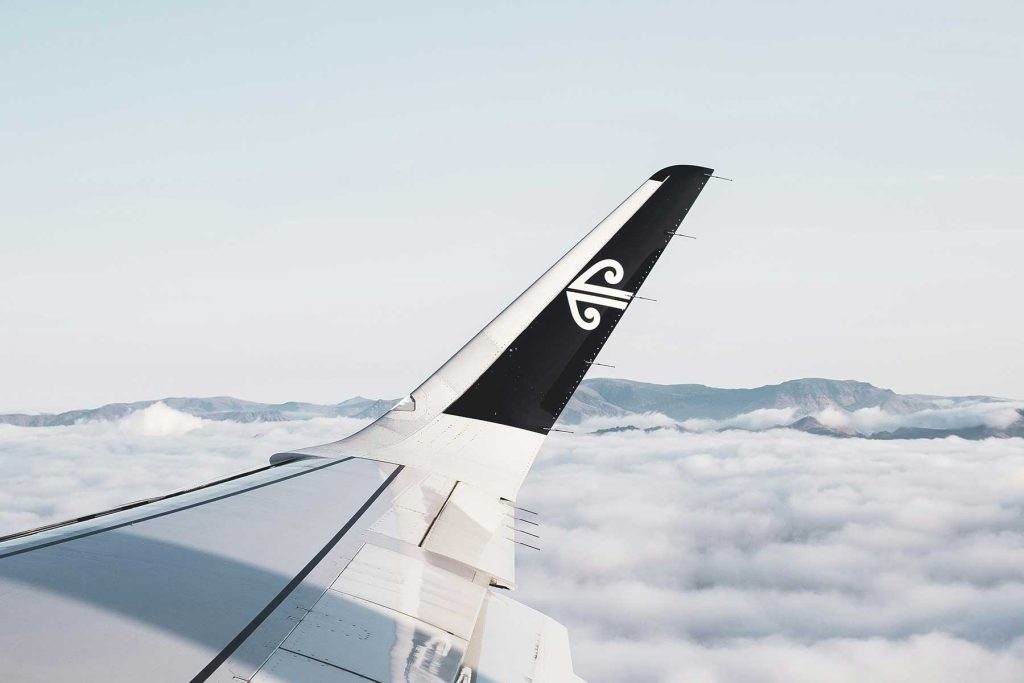 An aircraft wing above the clouds