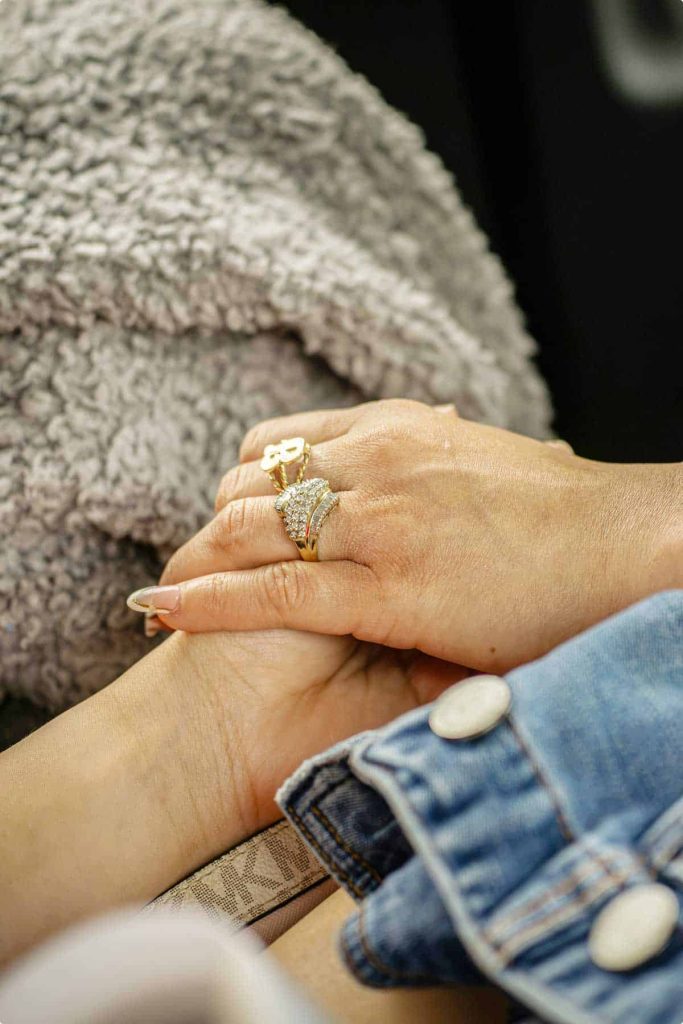 One person holding another person's hand
