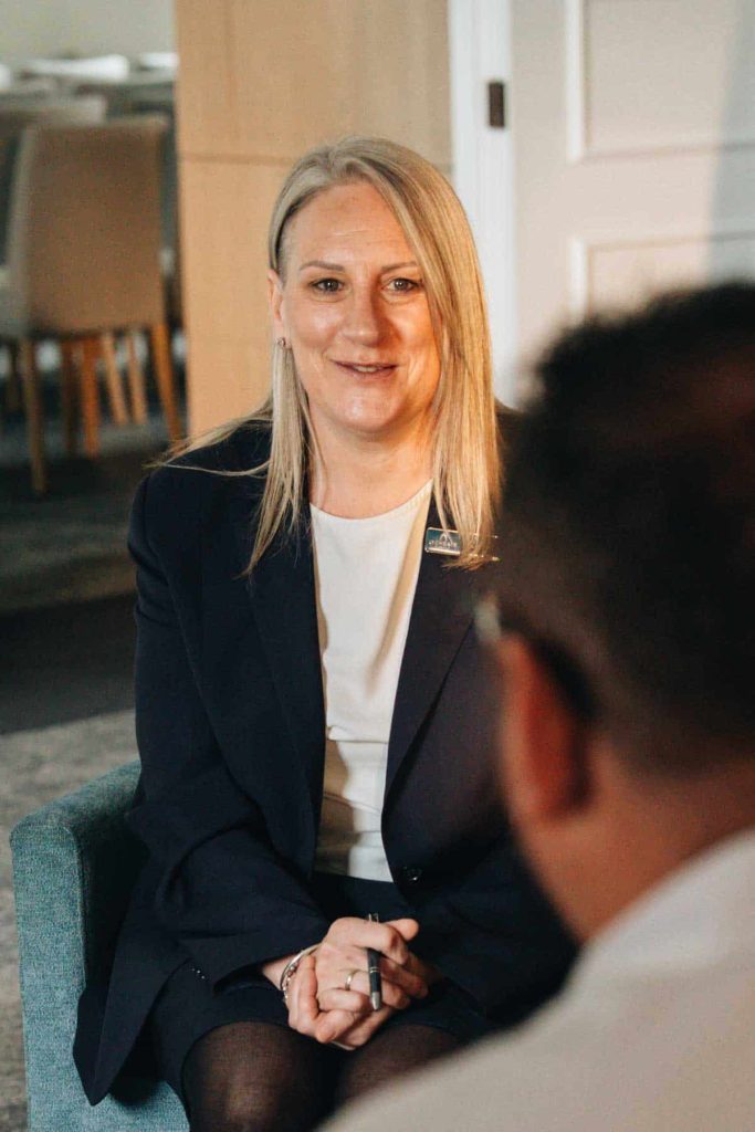 Kerry, a Lychgate funeral director, sitting with a client to talk through their plans